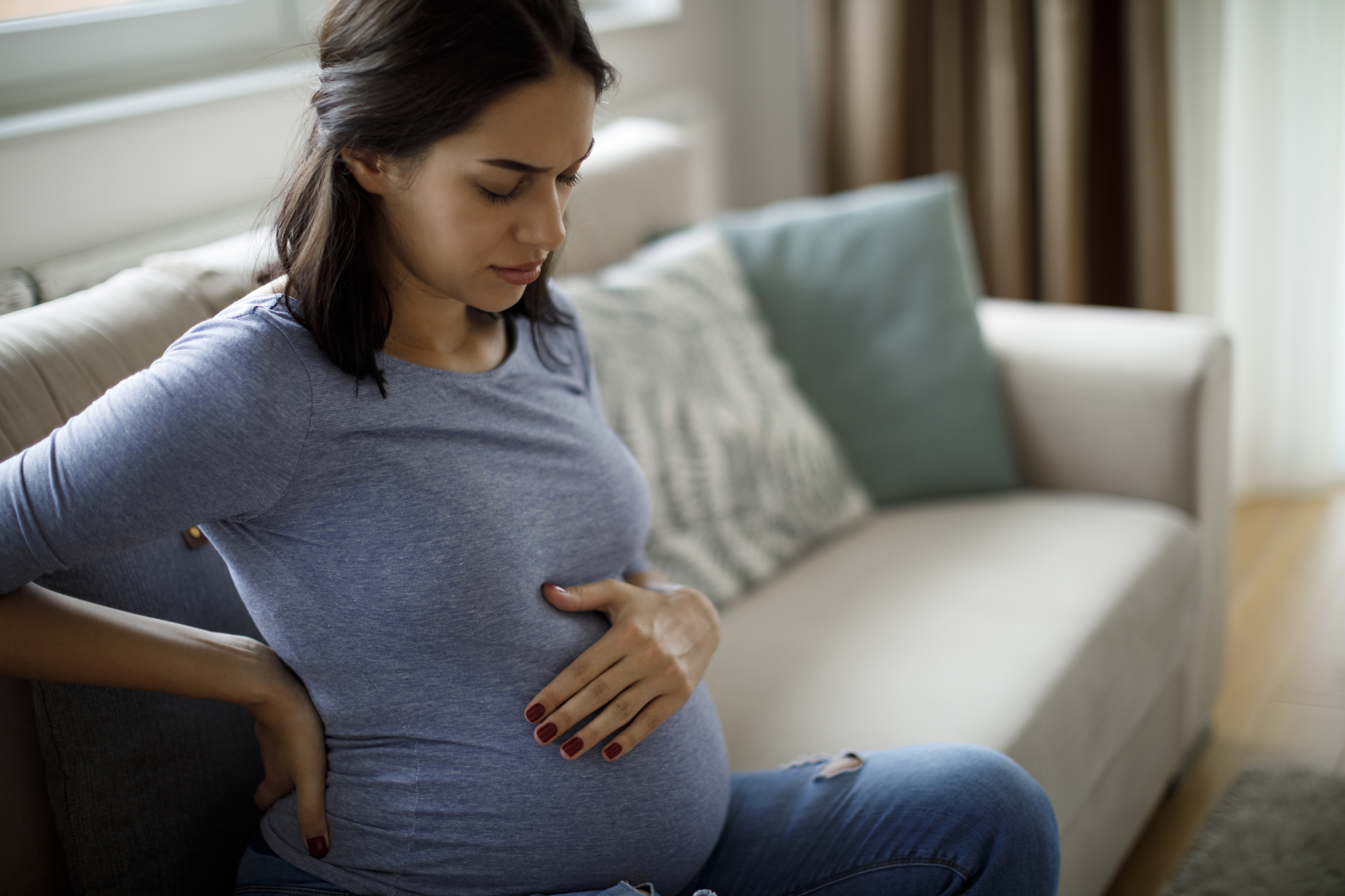 Young pregnant woman suffering from backache