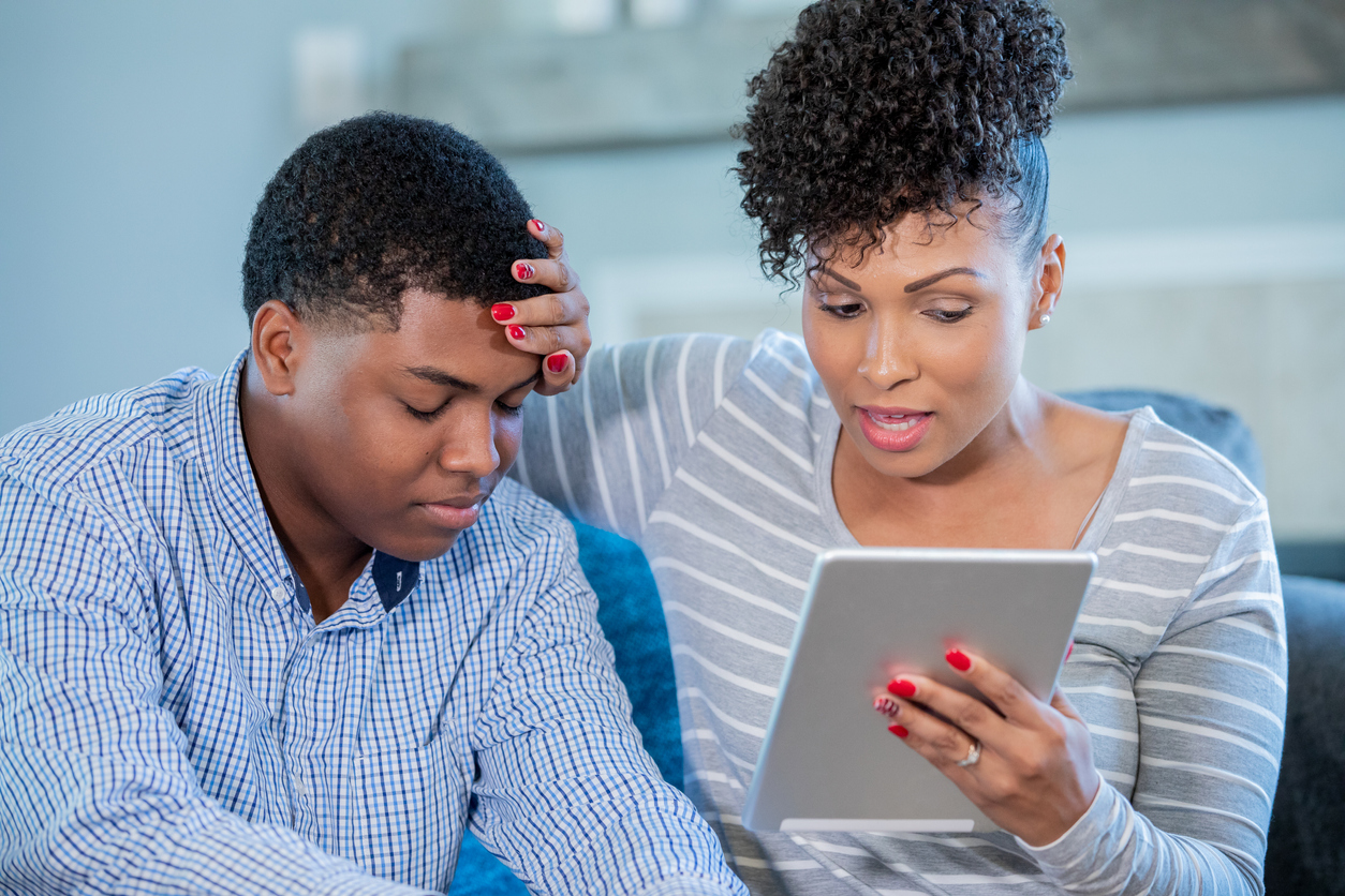 Mother on a video call with doctor with sick teenage son