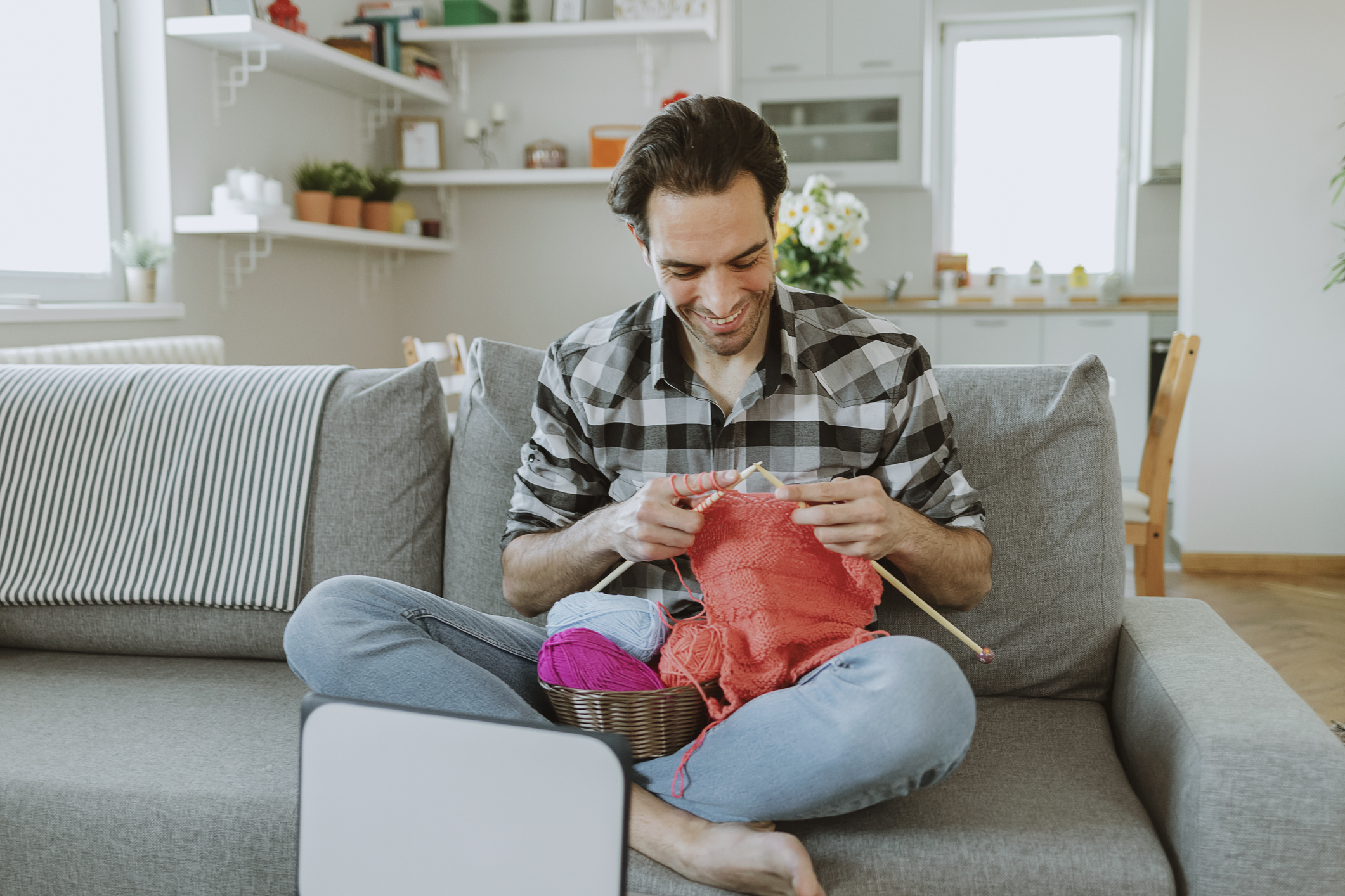 Man Watching Knitting Tutorial With Needles