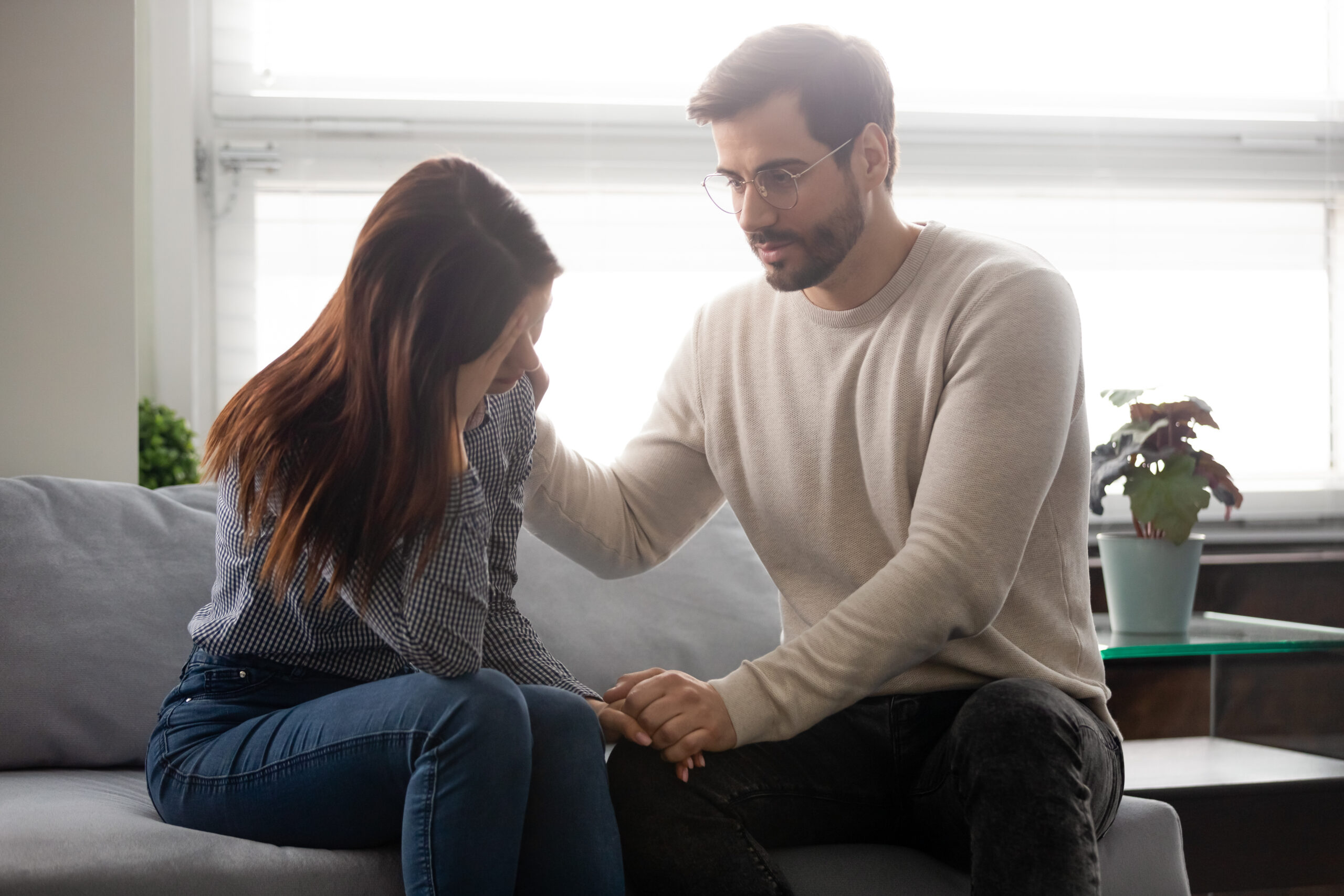 Guy reassures beloved girl holds her hand showing sincere care