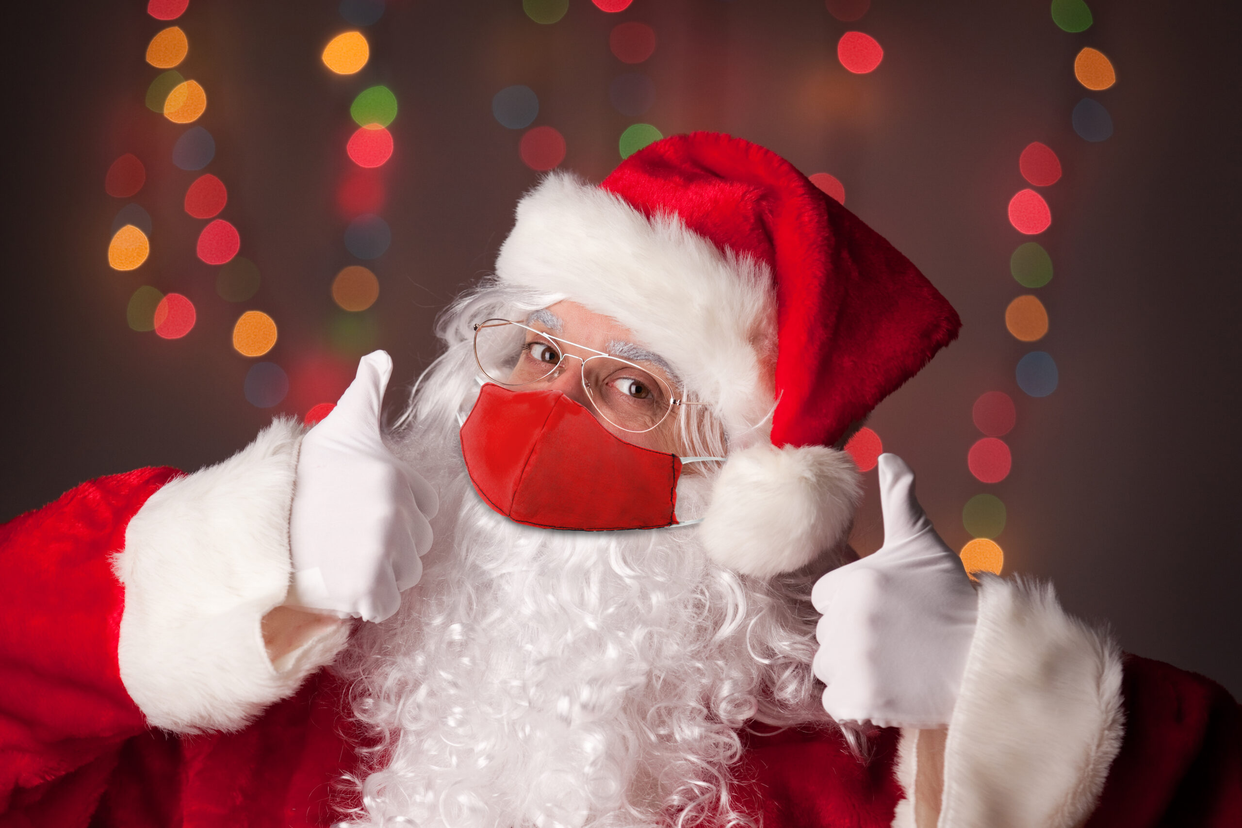 Santa Claus in Face Mask With Two Thumbs Up