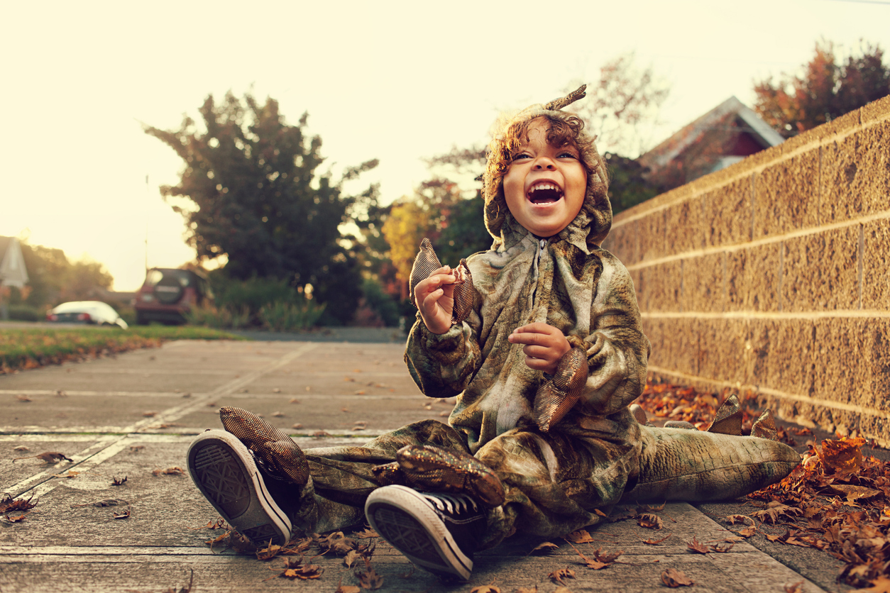 Young boy in dinosaur costume during Halloween