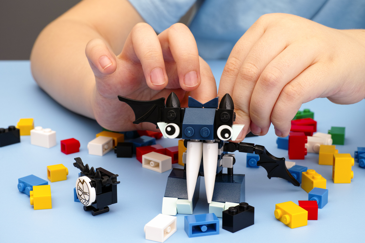 Child playing with Lego Mixel Vampos