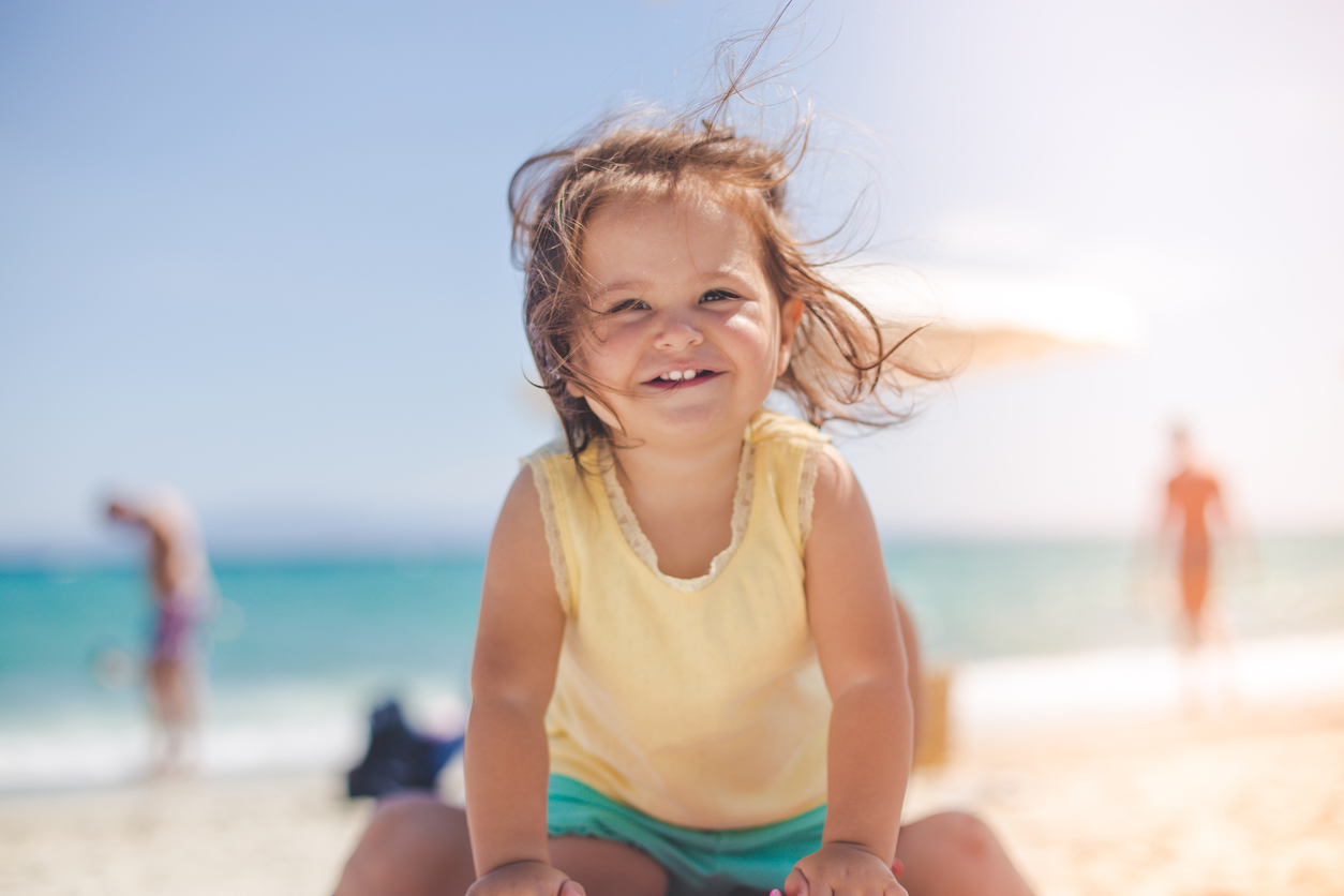 portrait of a cute baby girl on the beach