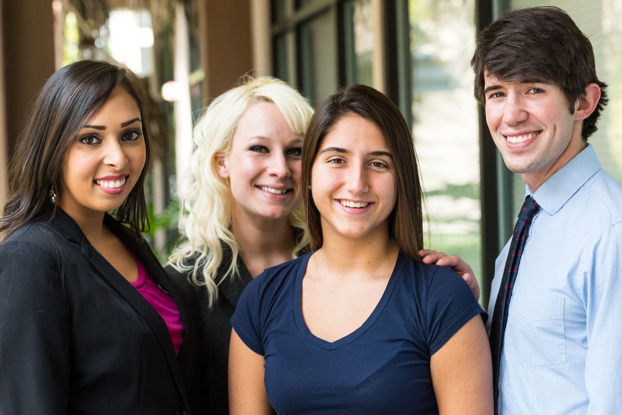 Young man posing with three young women