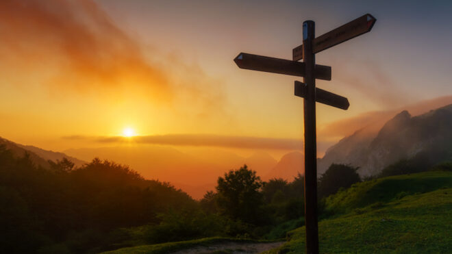 signpost in the mountain at sunset