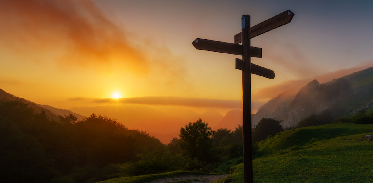 signpost in the mountain at sunset