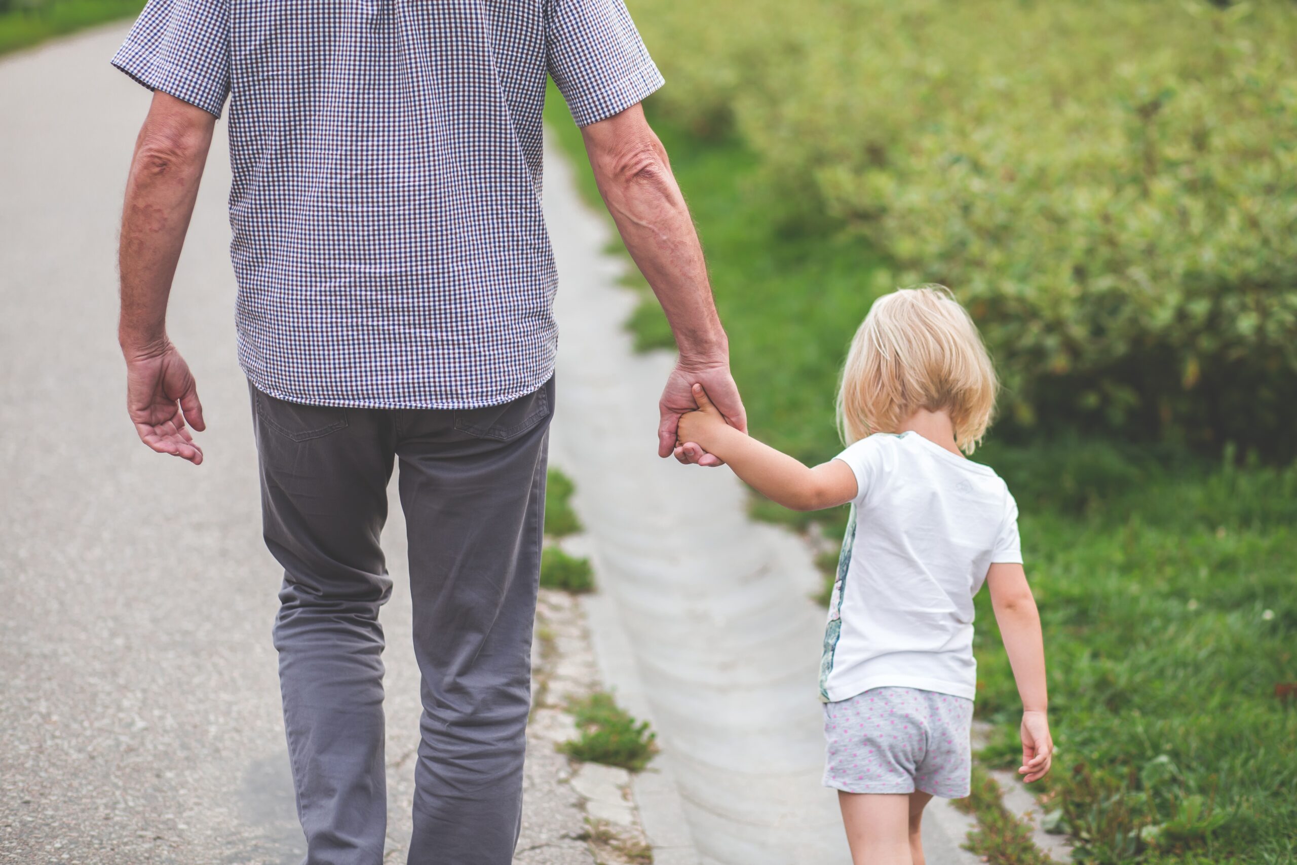 man-and-child-walking-near-bushes-during-daytime-167300.jpg