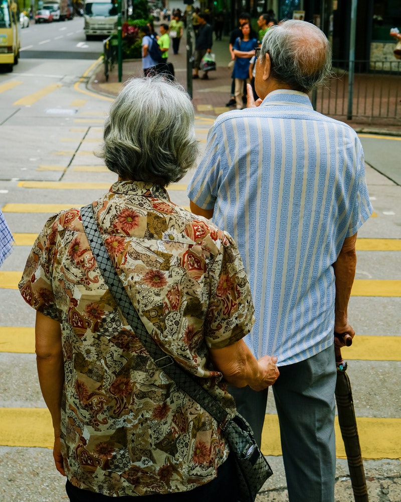 man-and-woman-standing-beside-pedestrian-lane-16359071.jpg