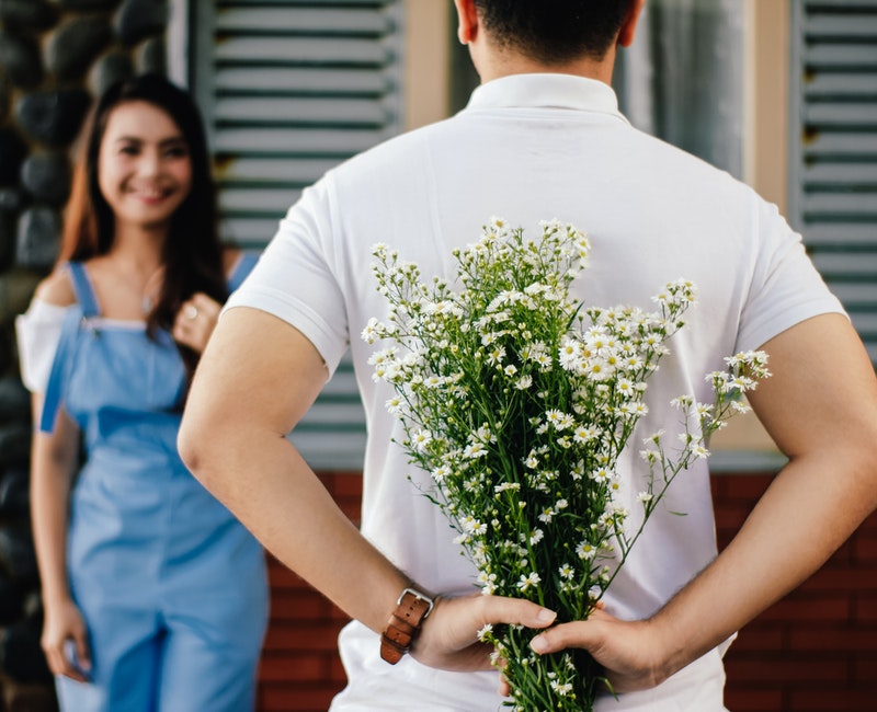 man-holding-baby-s-breath-flower-in-front-of-woman-standing-935789.jpg