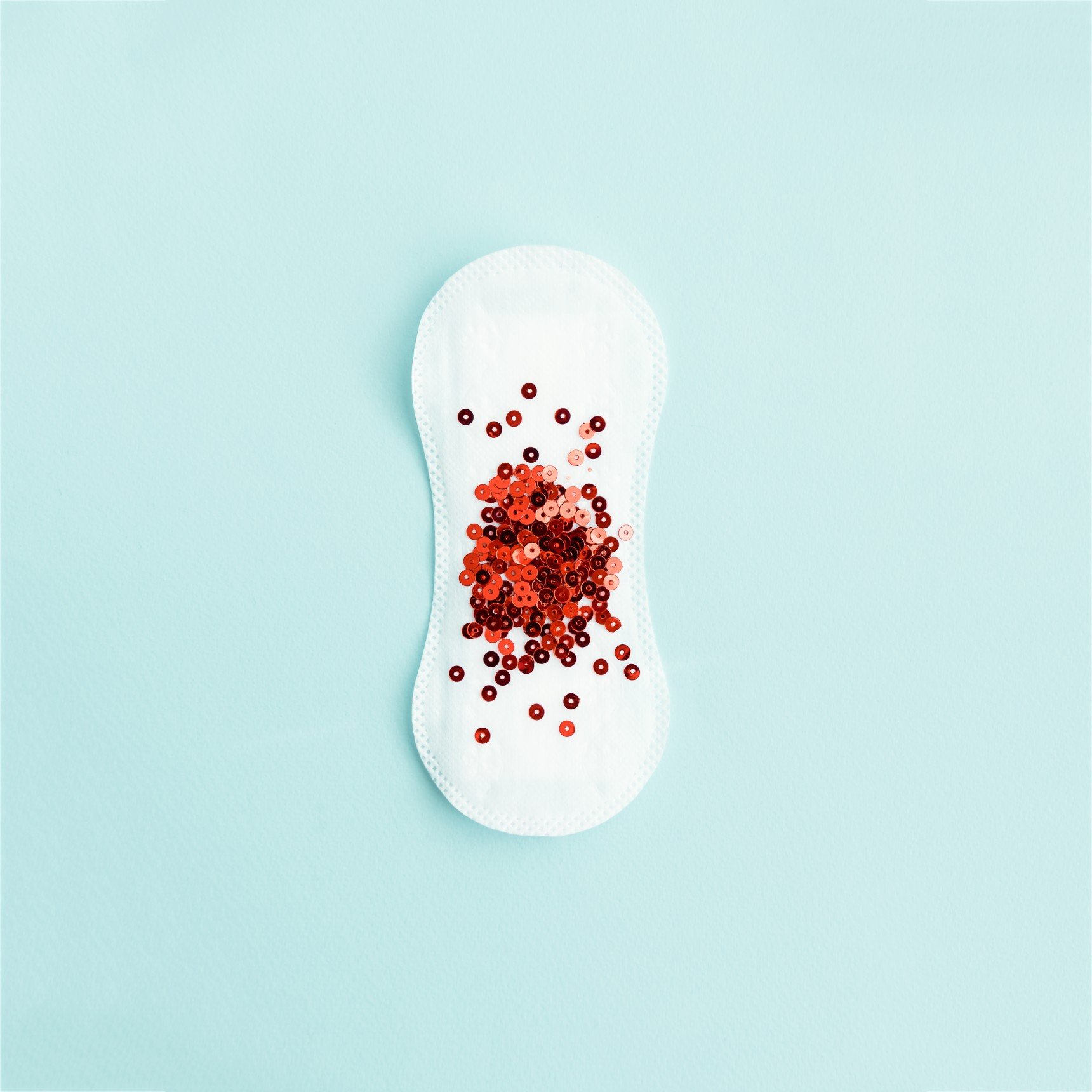 menstrual-pad-with-red-sequins-on-pastel-blue-colored-background-minimalist-creative-glamour-still_t20_4lAbzO.jpg