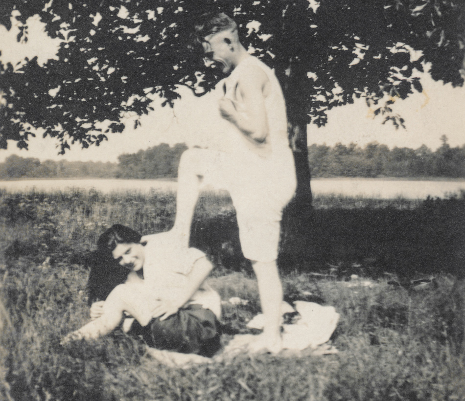 Man playfully steps on the back of a woman