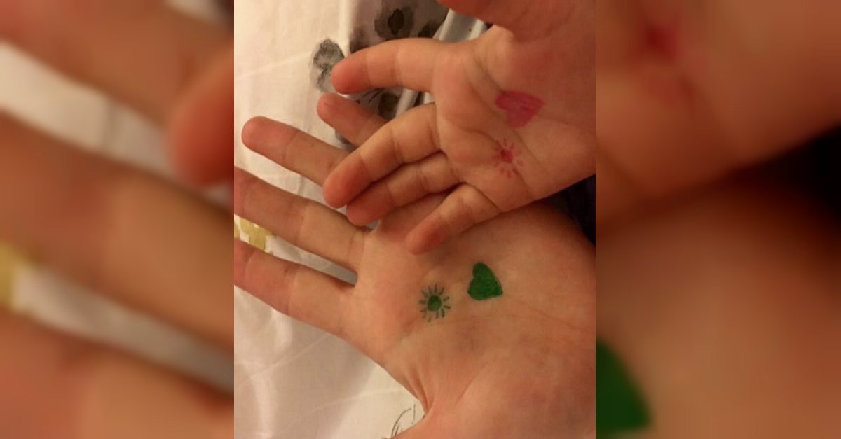 Mom Draws A Heart And Sun On Daughter's Hand To Remind Her She's Not Alone