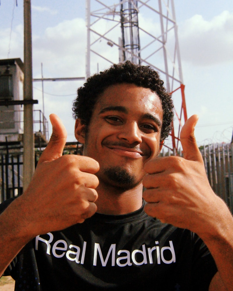 portrait-photo-of-smiling-man-in-black-real-madrid-printed-t-2480847.jpg