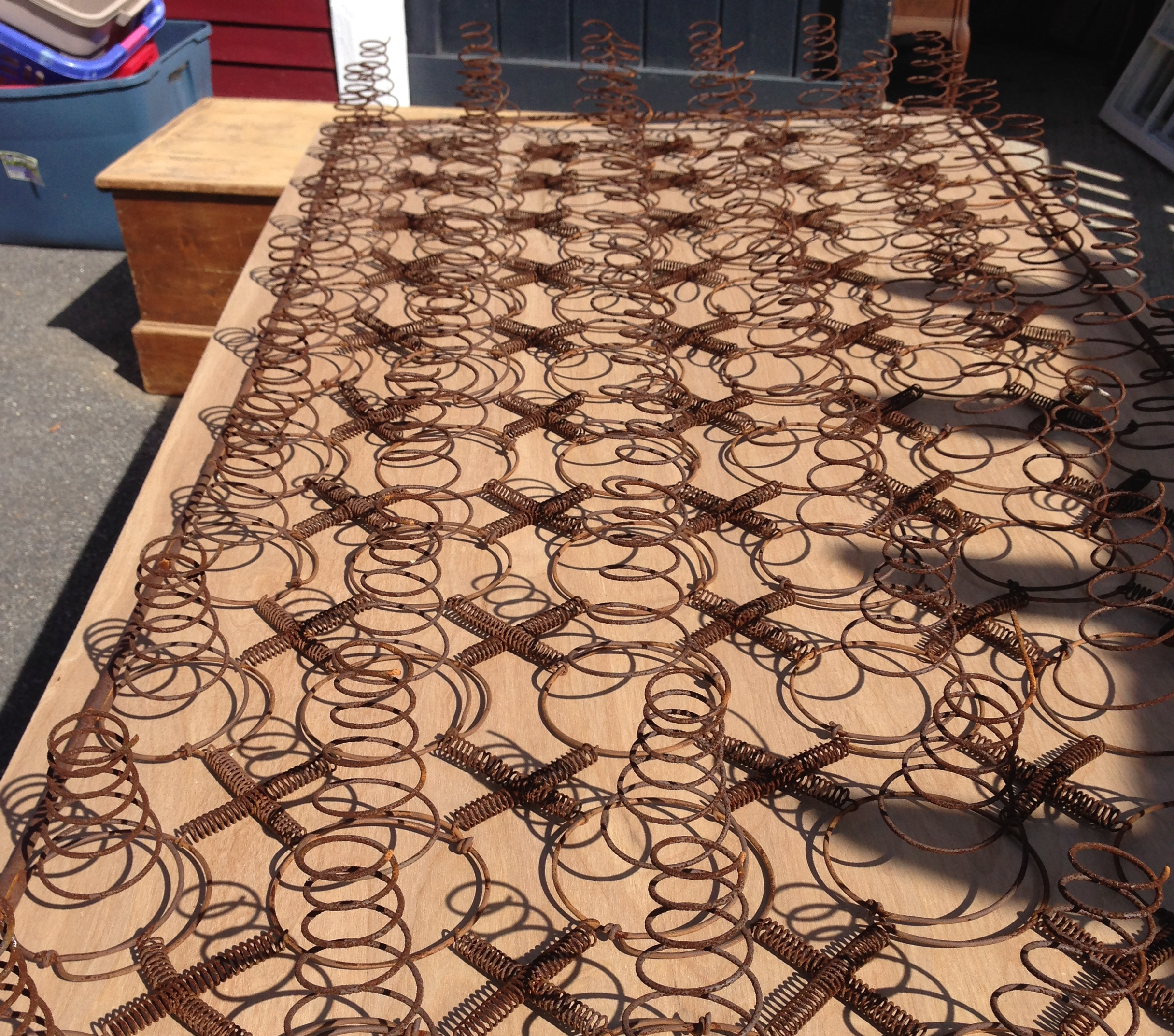 rusty-bedsprings-on-plywood-base.png