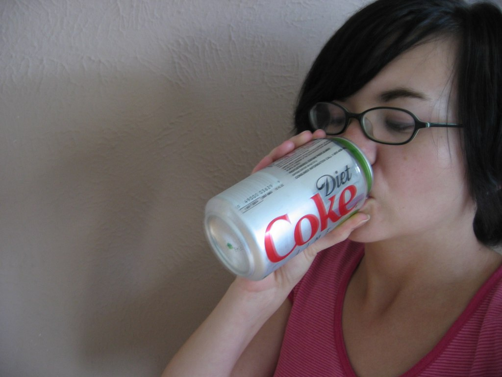 Drinking a soda.