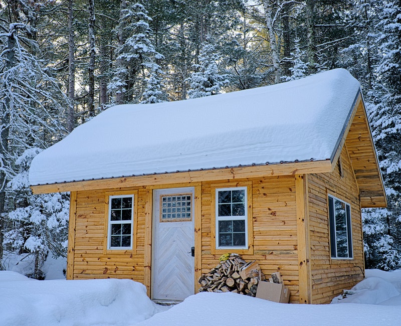 snow-covered-wooden-house-inside-forest-749231.jpg