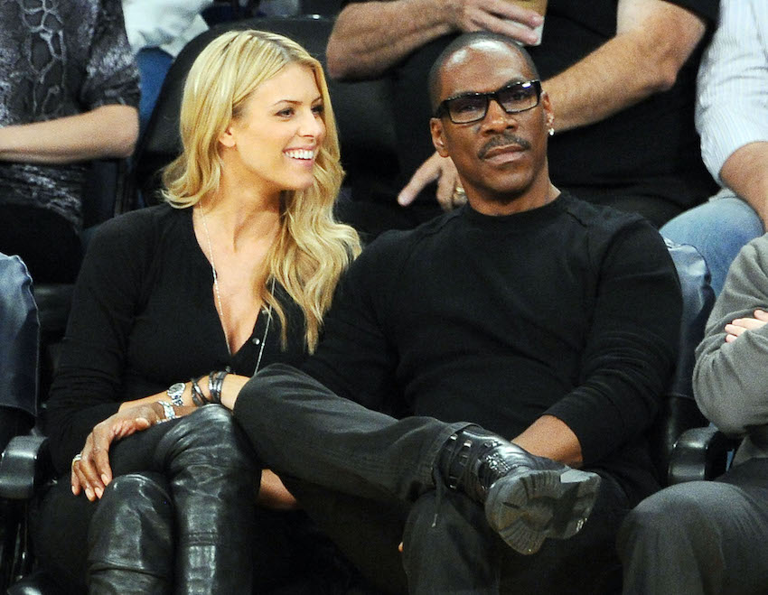 Eddie Murphy and Paige Butcher watch the Los Angeles Lakers in Los Angeles, CA