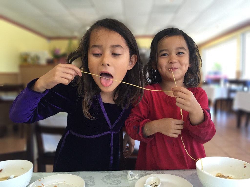 two-sisters-eating-noodles_t20_o1ap4R.jpg