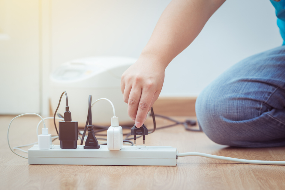 man unplugged plug to save on energy