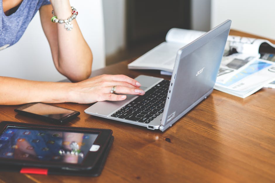 woman-hand-smartphone-laptop-1.jpg