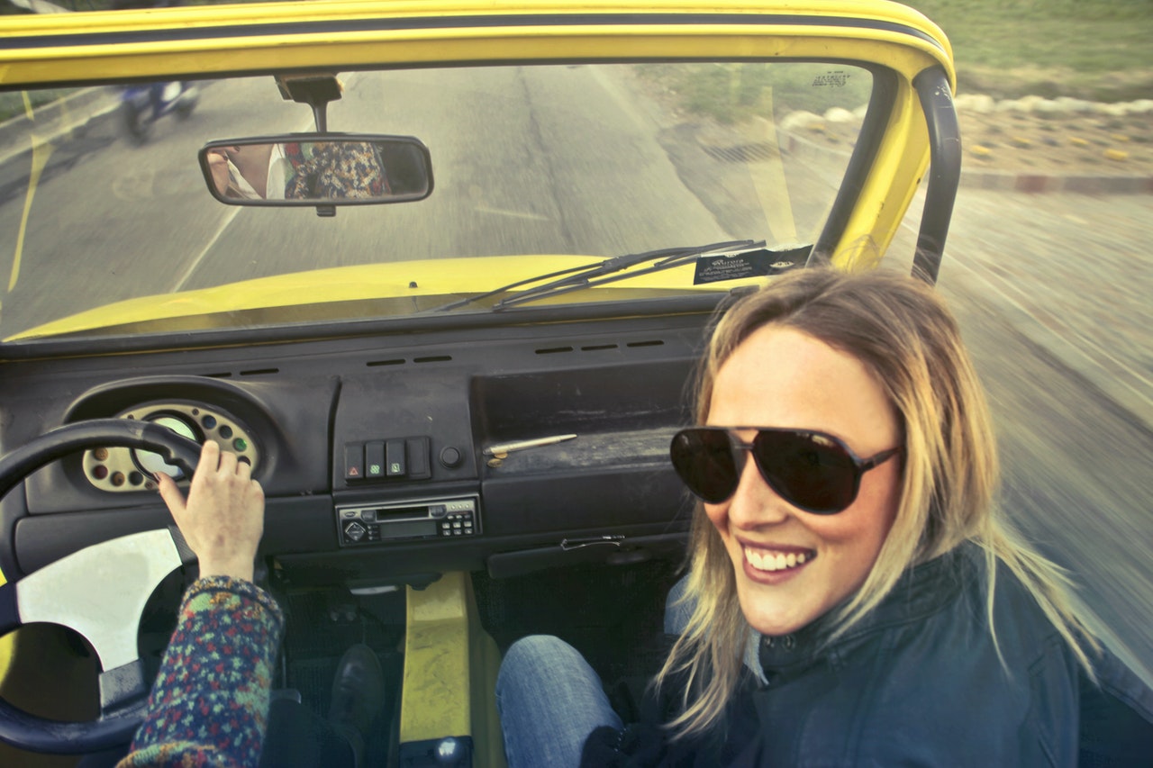 woman-in-black-aviator-sunglasses-sitting-on-car-s-passenger-760015.jpg