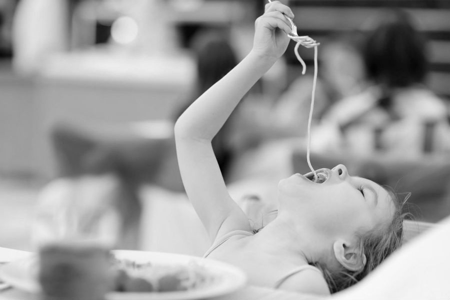 young-girl-eating-pasta-in-restaurant.jpg