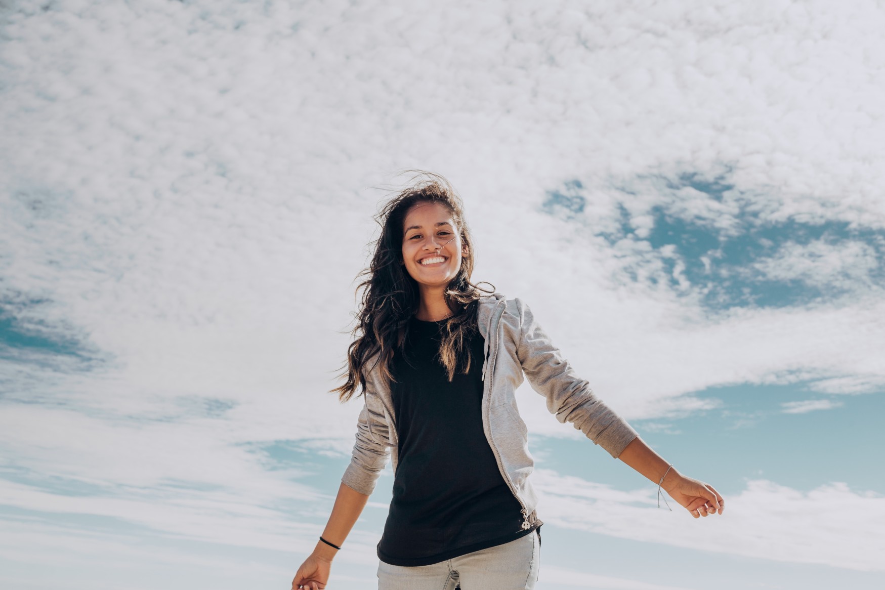 young-woman-smiling-against-blue-sky_t20_Ope06E.jpg