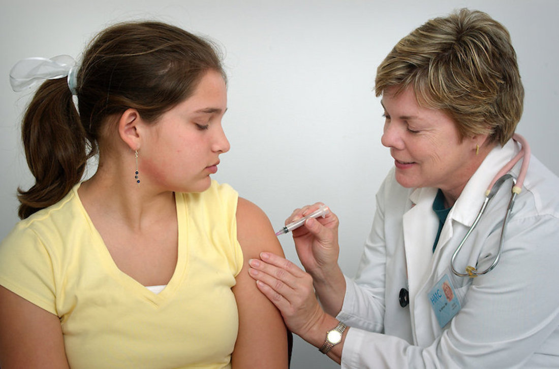 16727-a-nurse-giving-a-young-girl-a-vaccine-shot-pv.jpg