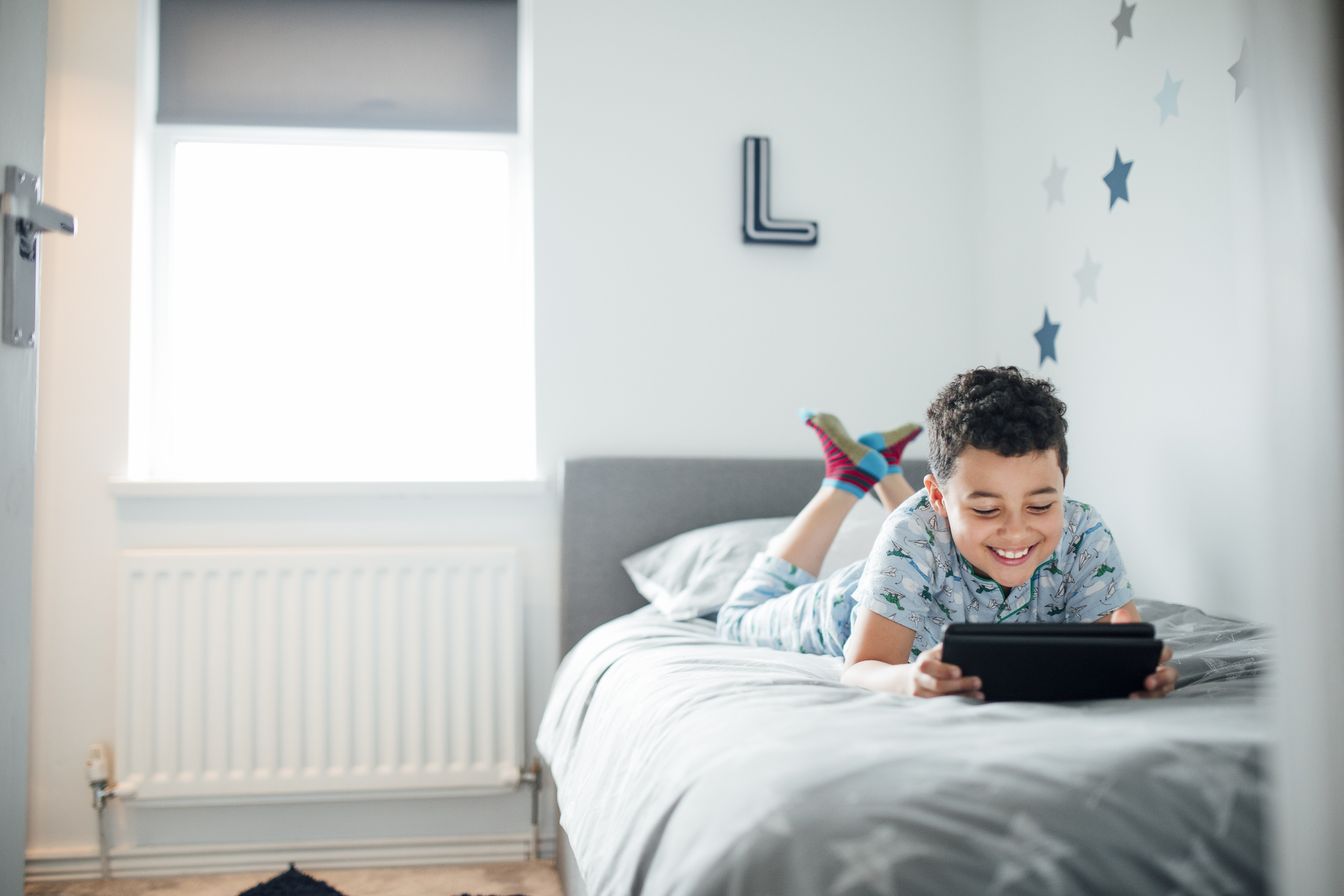 Boy Using Digital Tablet in the Morning