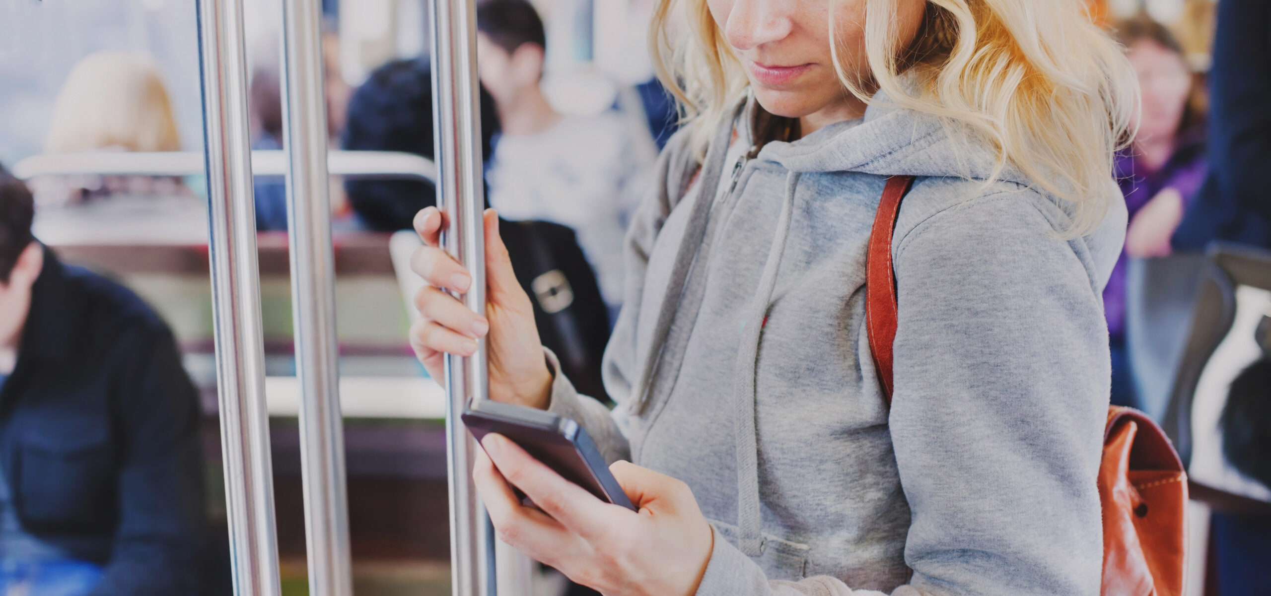 person looking at the screen of smart phone in subway