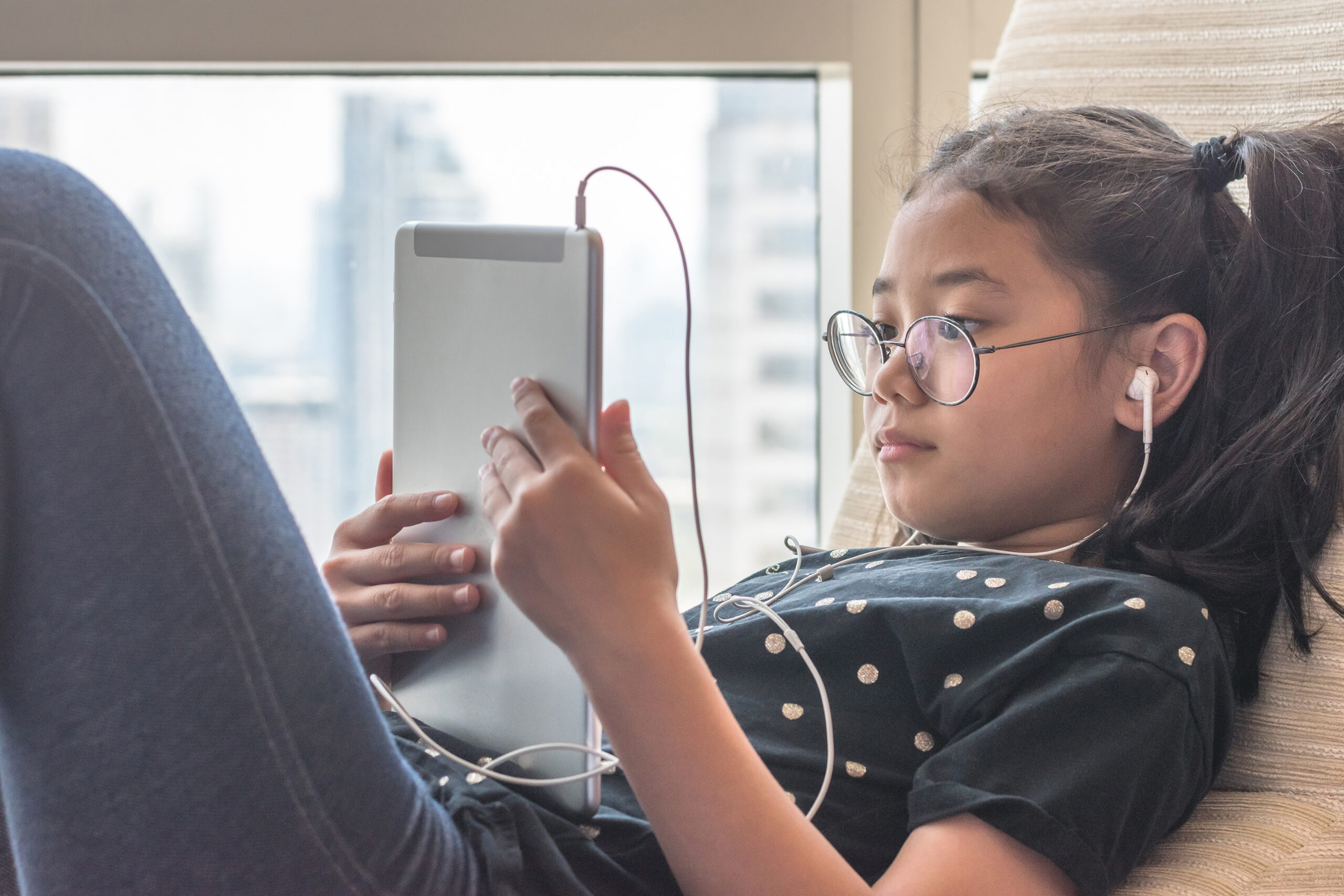 Digital technology lifestyle of school girl child or student using wireless internet for distance learning application and reading e-book app on mobile ipad smart device multimedia computer tablet