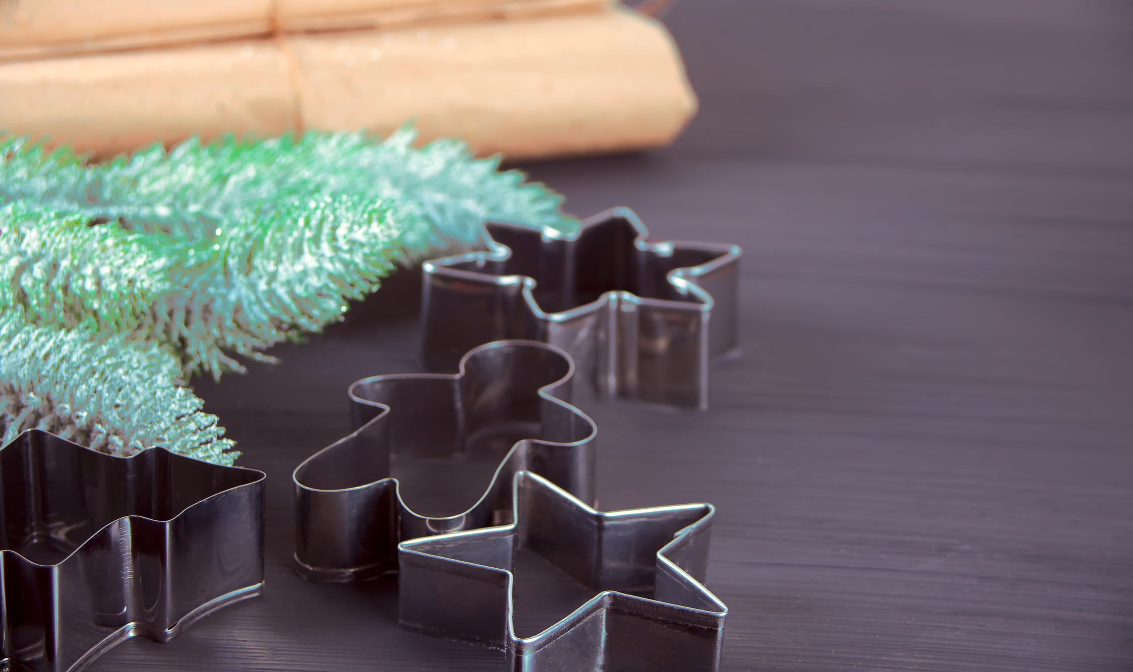 Christmas cookie cutters tree, gingerbread man, star on the wooden table