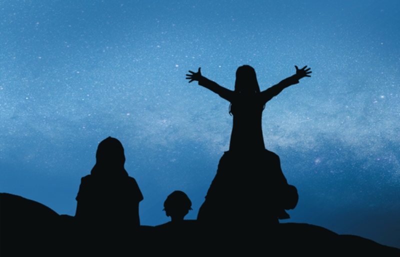 Family looking up to the moon.