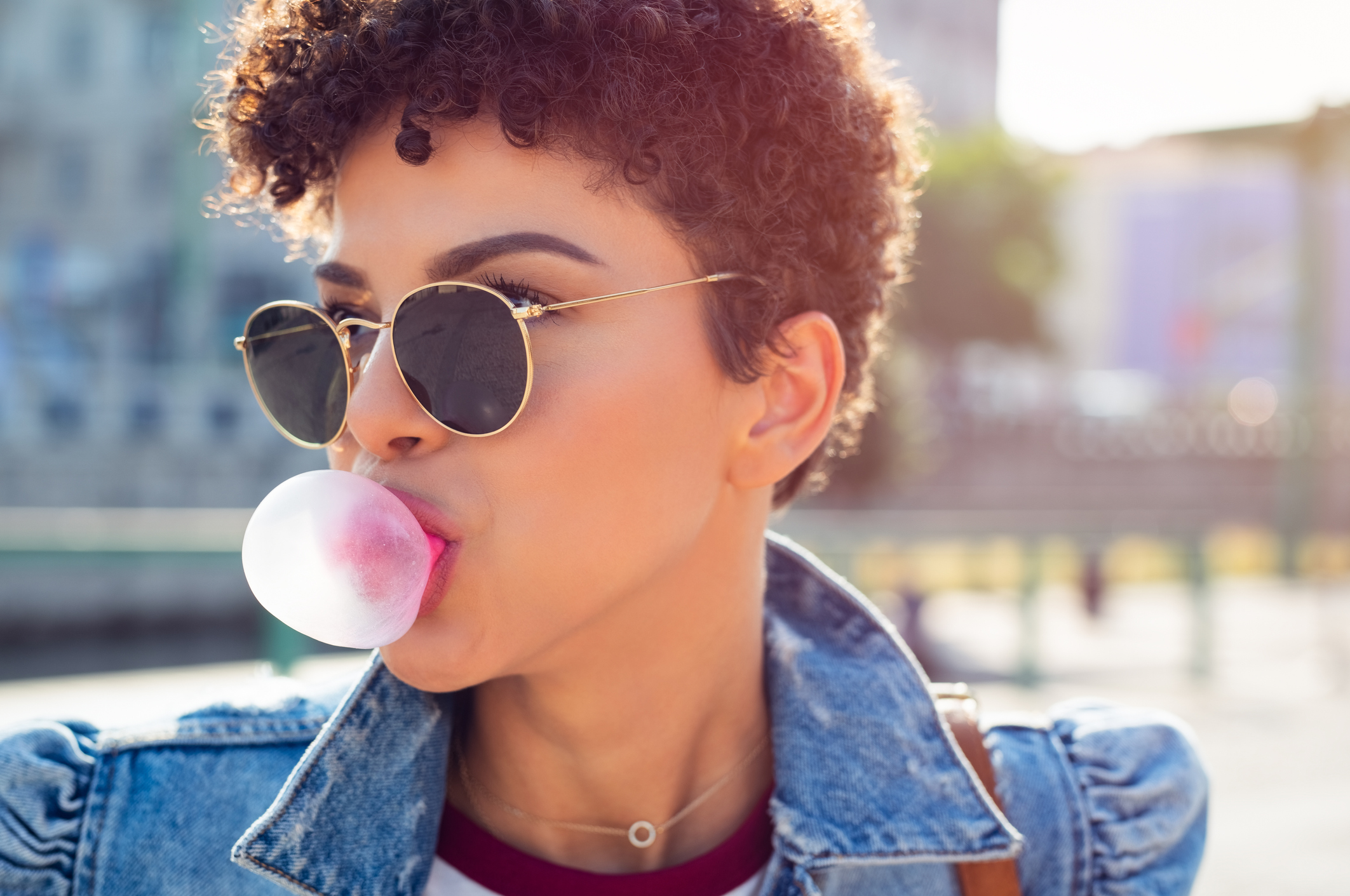 Woman blowing bubble gum balloon