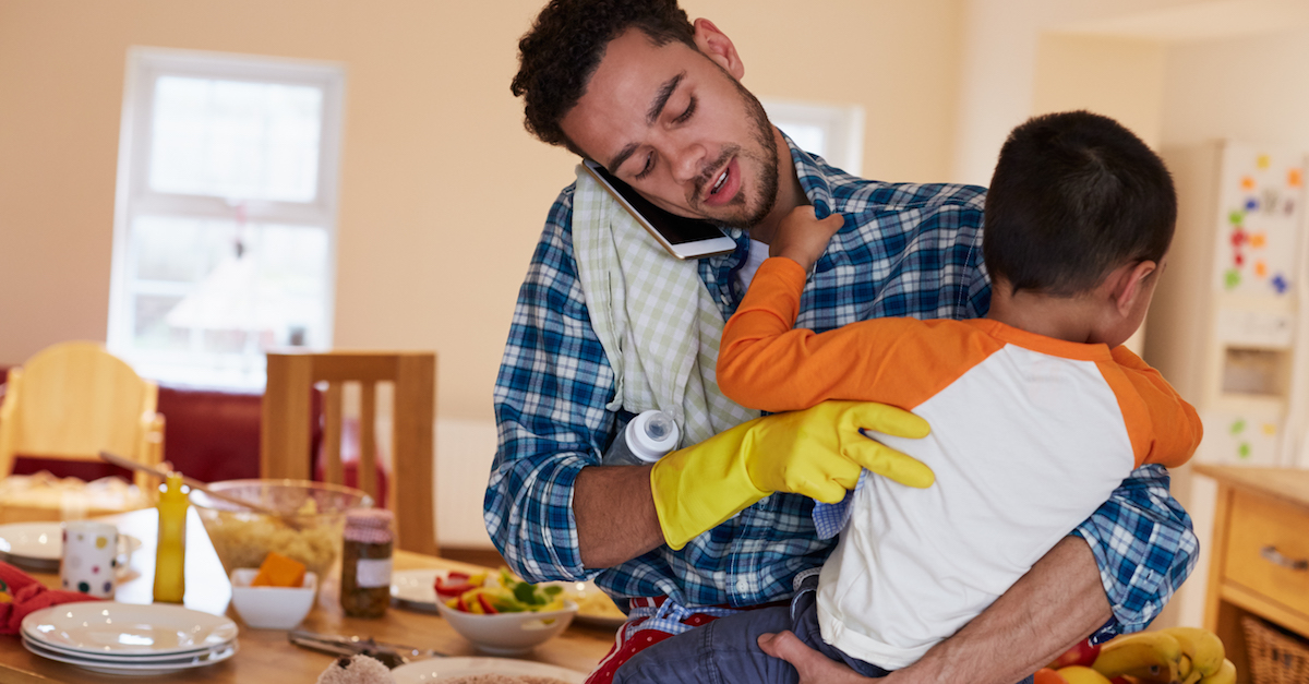 Busy Father Looking After Son Whilst Doing Household Chores