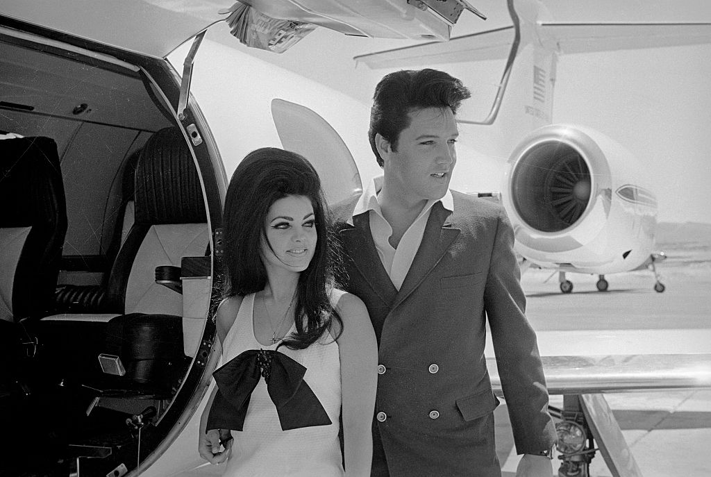 Elvis and Priscilla Presley Posing near Airplane