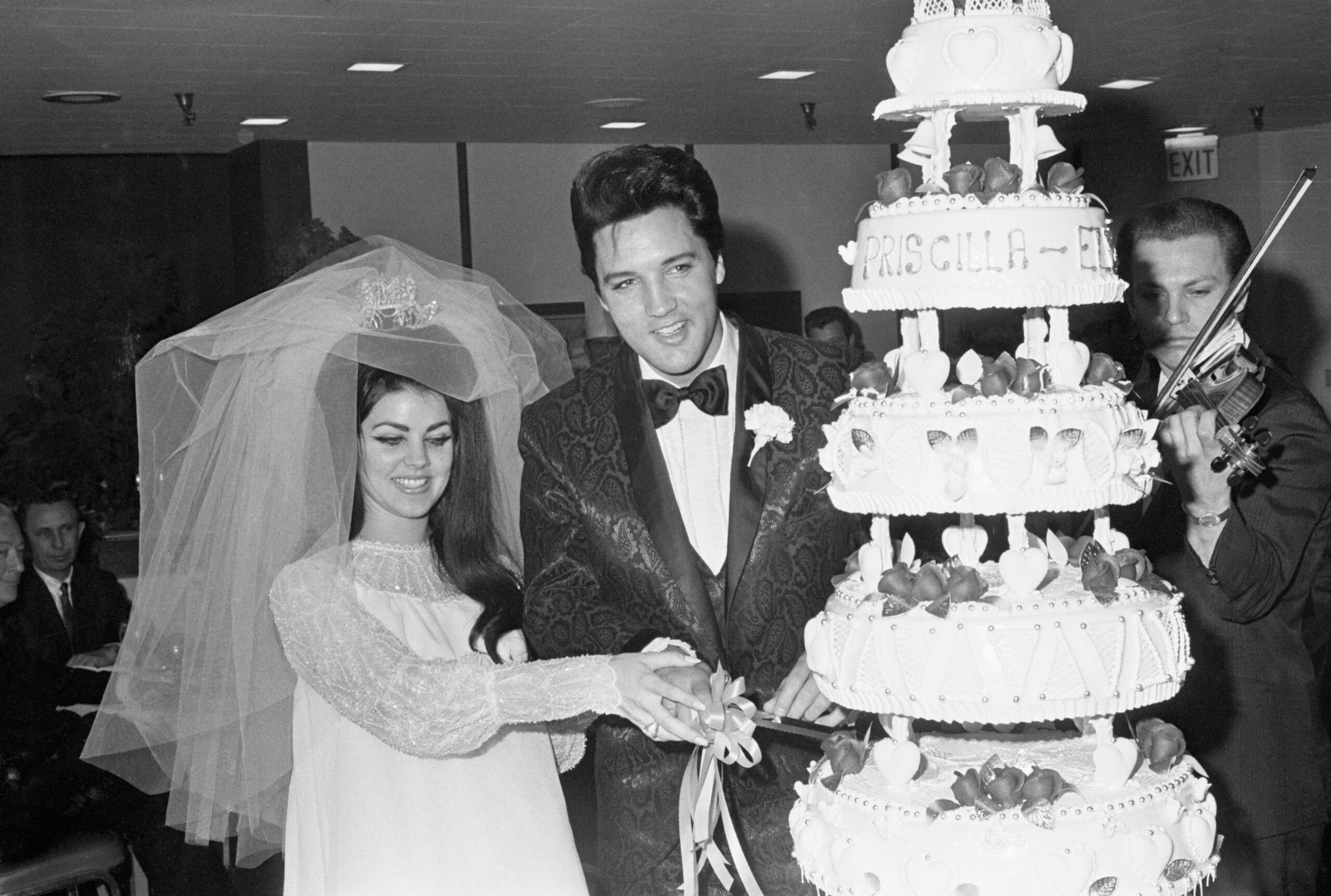 Elvis and Priscilla Presley with Wedding Cake