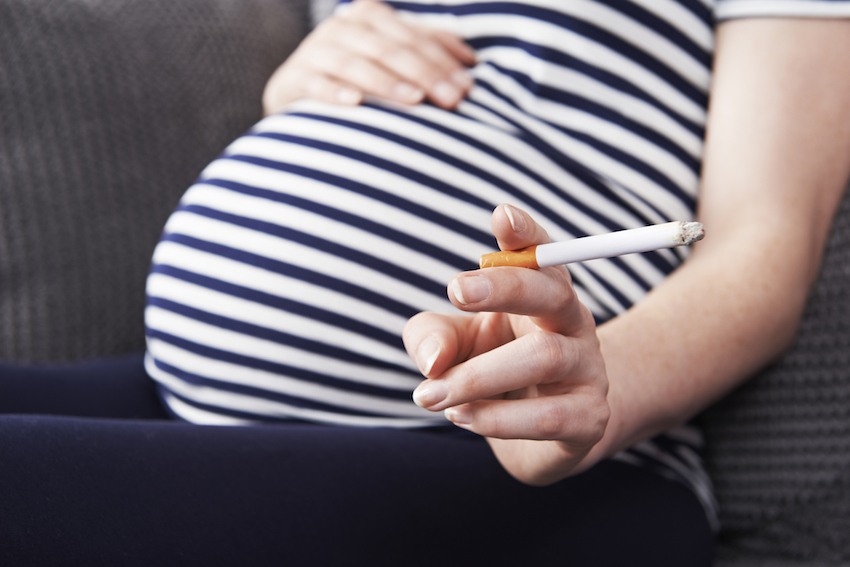 Close Up Of Pregnant Woman Smoking Cigarette