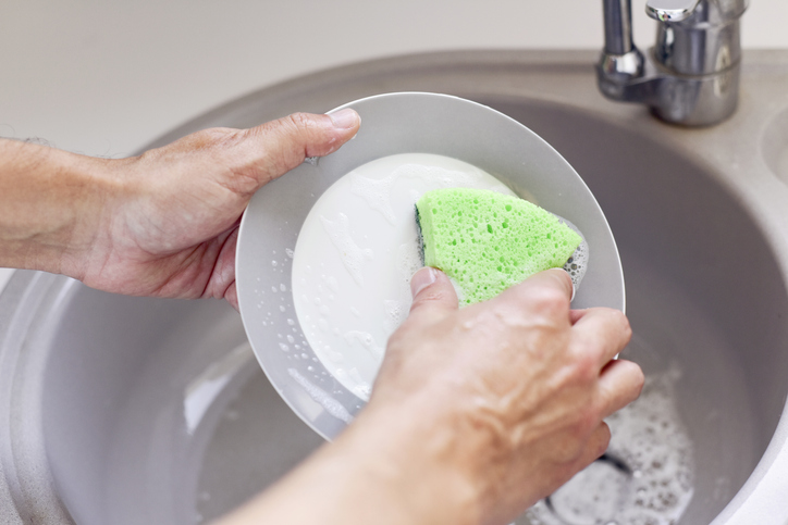 young man washing dishes