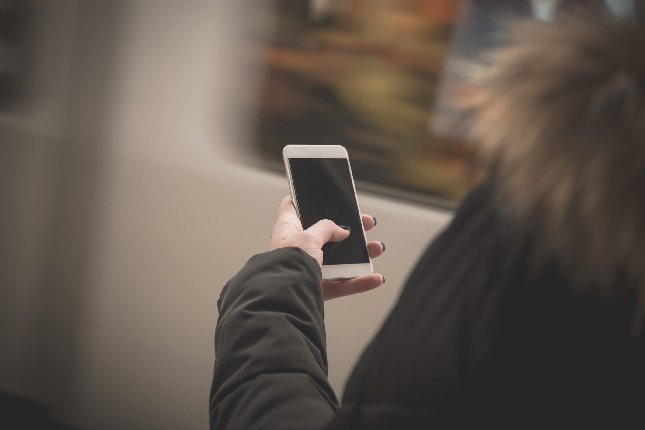 Female using smartphon at the train station