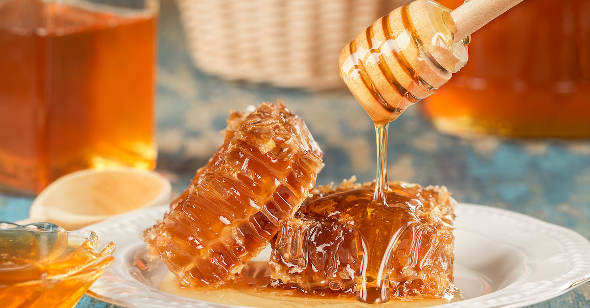 Sweet honeycomb and wooden Honey dripping