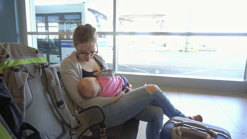 A Woman Breastfeeding her Child at the Airport