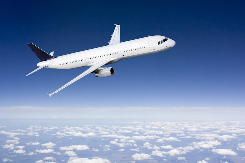 Passenger airplane flying above clouds