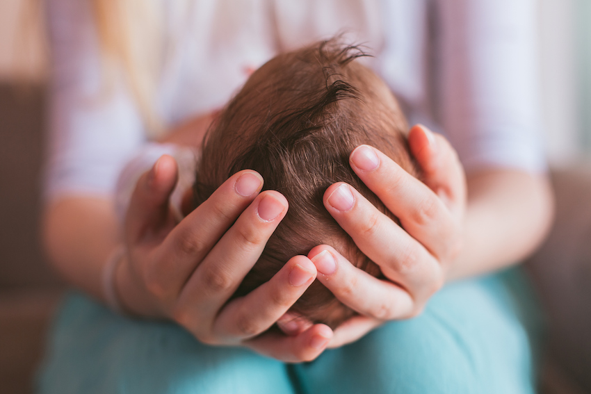 Mother holding newborn baby boy