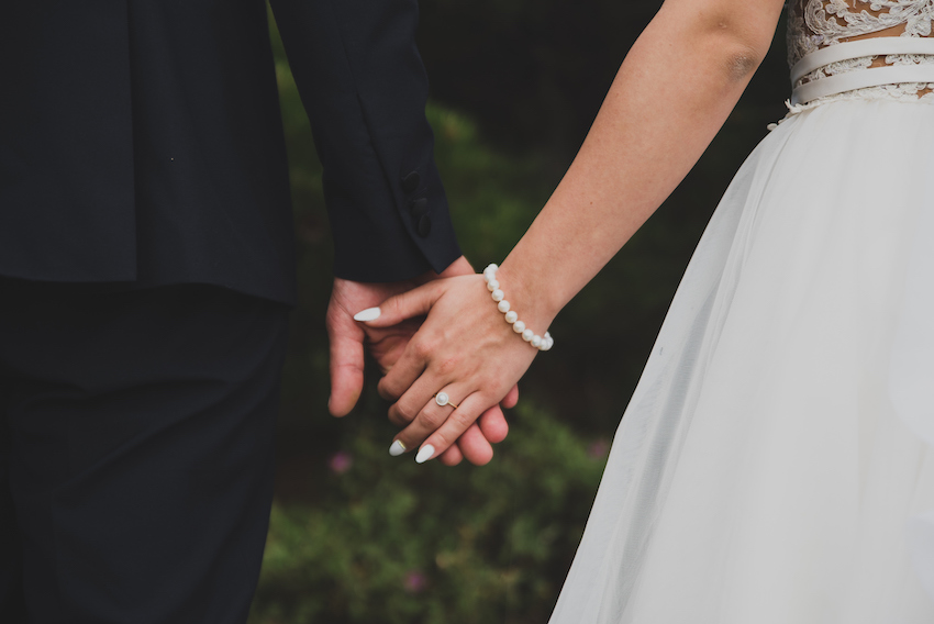 Young married couple holding hands