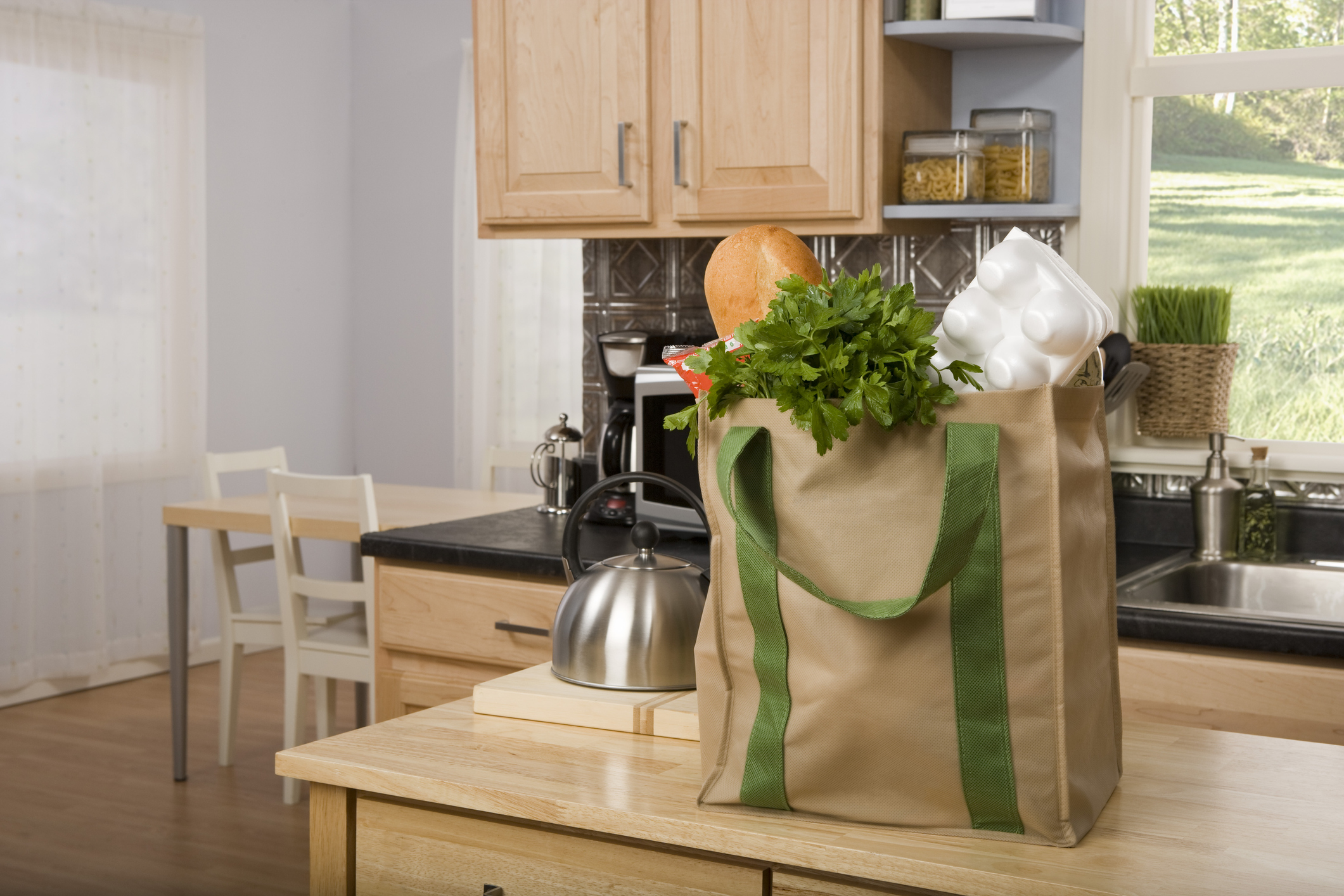 Reusable bag filled with groceries on kitchen counter