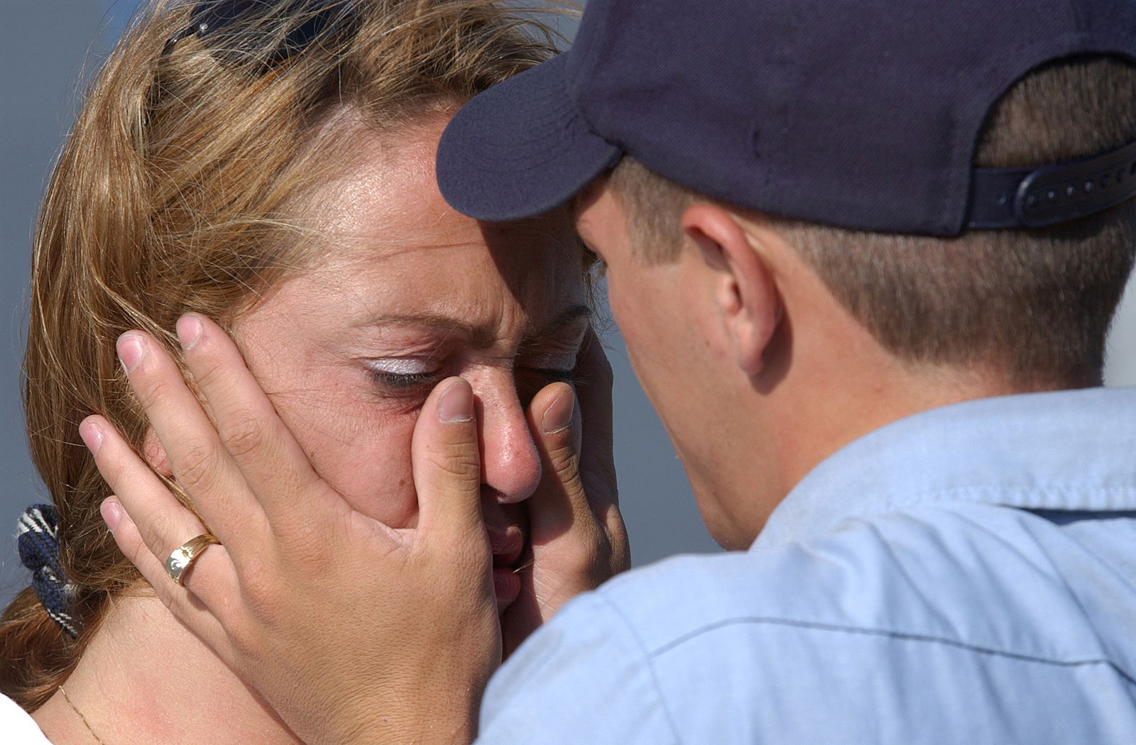 US_Navy_020620-N-1110A-505_Aviation_Structural_Mechanic_Airman_Nathaniel_Wellman_wipes_away_the_tears_of_a_loved_one.jpg