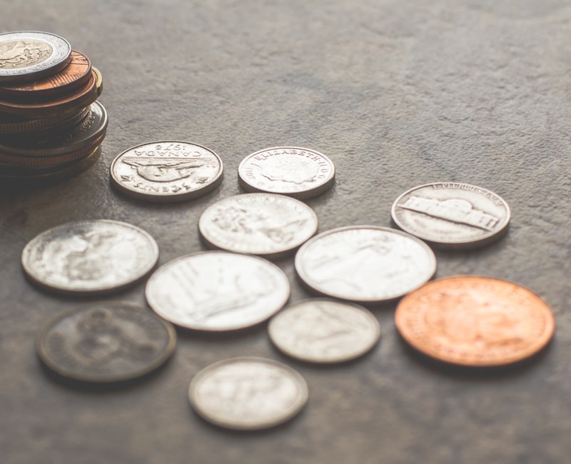 assorted-silver-and-gold-colored-coins-on-gray-surface-1006060.jpg