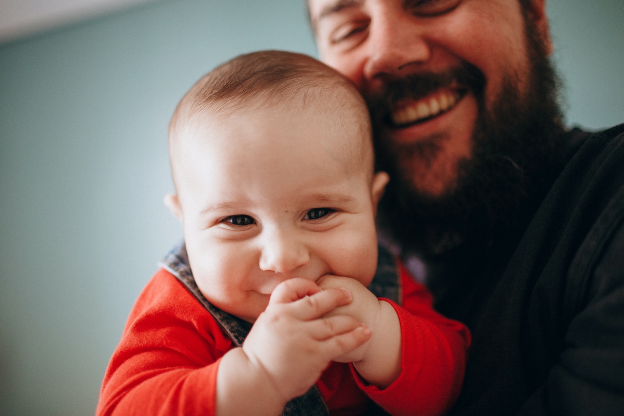 bearded-man-carrying-his-son-4409280.jpg